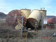 Old tank farm and piping in Hughes