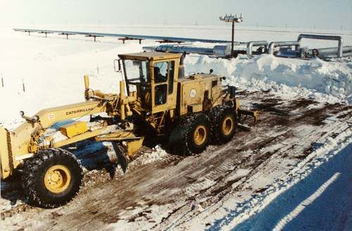 grader clearing snow
