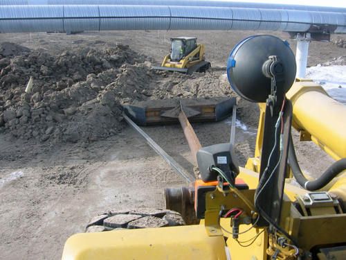 pushing veggie mat beneath pipeline
