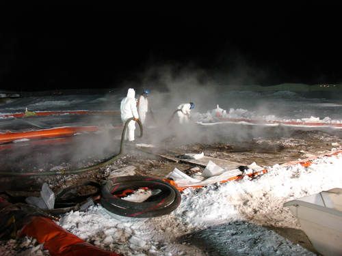 Workers cleaning tundra in winter