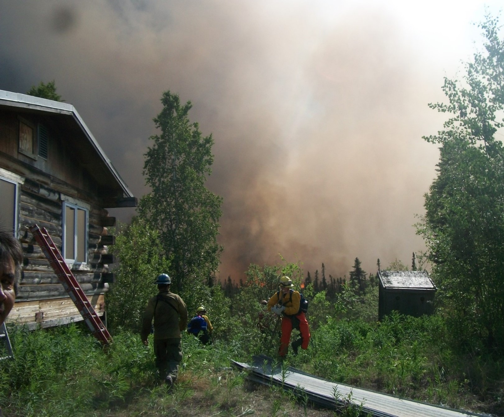 Firefighters Battling Fire Approaching Cabin