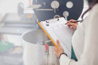 Woman monitoring food using a clipboard