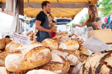 Man selling bread at a farmers market