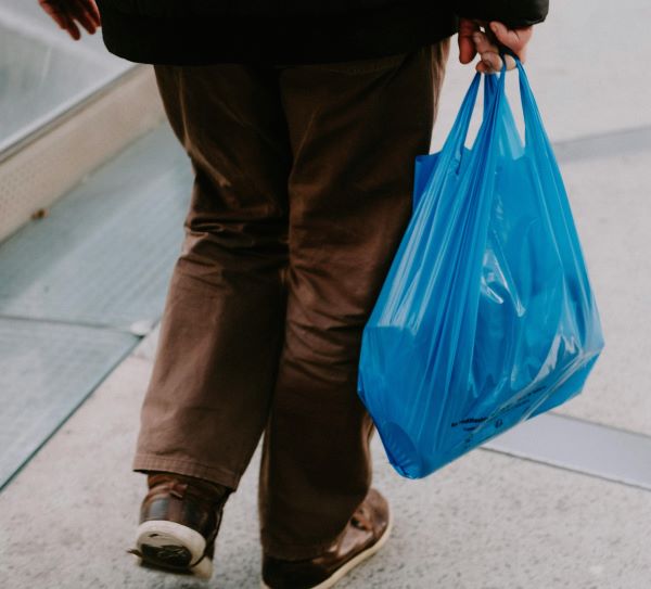 Shopper with plastic bag